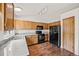 Well-lit kitchen featuring wooden cabinets, black appliances, and granite countertops at 250 Cypress Ln, Broomfield, CO 80020