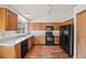 Traditional kitchen featuring wood cabinets, modern appliances, and wood flooring at 250 Cypress Ln, Broomfield, CO 80020