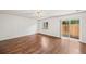 Bright living room featuring wood floors and sliding glass door to the outside at 250 Cypress Ln, Broomfield, CO 80020