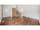 Inviting room with hardwood floors, a staircase, and a door at 250 Cypress Ln, Broomfield, CO 80020