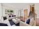 Bright living room with hardwood floors, large windows, and stylish white furniture with blue accents at 250 Cypress Ln, Broomfield, CO 80020