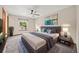Comfortable main bedroom with a ceiling fan, a large window, and modern decor at 250 Cypress Ln, Broomfield, CO 80020