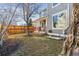 Large, grassy backyard with mature trees and partial fencing at 7441 E 8Th Ave, Denver, CO 80230