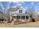 Charming two-story home with a inviting covered front porch and manicured lawn at 7441 E 8Th Ave, Denver, CO 80230