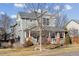 Beautiful two-story home featuring a covered front porch with stately columns at 7441 E 8Th Ave, Denver, CO 80230