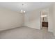 Carpeted bedroom with chandelier light fixture and ensuite bathroom access at 323 Josef Cir, Fort Lupton, CO 80621