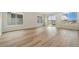 Spacious living room with wood-style flooring and large windows offering abundant natural light at 323 Josef Cir, Fort Lupton, CO 80621