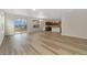 Open floor plan showcasing wood-style flooring and sliding glass doors to the backyard at 323 Josef Cir, Fort Lupton, CO 80621
