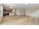 Open floor plan featuring wood-style flooring, leading into the kitchen with modern white island at 323 Josef Cir, Fort Lupton, CO 80621