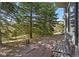 View of stone patio with seating, mature trees, and views at 481 Sunrise Dr, Golden, CO 80401