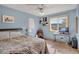 Airy blue bedroom featuring a desk, large window with a view, and decorative artwork at 481 Sunrise Dr, Golden, CO 80401