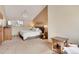 Bright bedroom featuring a vaulted ceiling, neutral color palette, and a large picture window at 481 Sunrise Dr, Golden, CO 80401