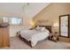 Charming bedroom with a chandelier, neutral walls, and a view overlooking the outdoors at 481 Sunrise Dr, Golden, CO 80401