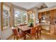Cozy dining area with large windows showcasing the outdoor view and a stylish light fixture at 481 Sunrise Dr, Golden, CO 80401