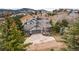 Inviting two-story home with a two-car garage, mature trees, and landscaped front yard at 481 Sunrise Dr, Golden, CO 80401