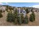 View of back exterior featuring mature trees and walk out lower level at 481 Sunrise Dr, Golden, CO 80401
