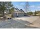Spacious three-car garage with a wide driveway and mature trees surrounding the property at 481 Sunrise Dr, Golden, CO 80401