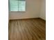 Bedroom with hardwood floors and a window offering natural light at 4400 S Quebec St # 102R, Denver, CO 80237