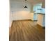 A dining room featuring hardwood floor with a hanging light in front of the kitchen at 4400 S Quebec St # 102R, Denver, CO 80237