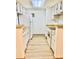 Functional galley kitchen with white cabinetry and appliances at 4400 S Quebec St # 102R, Denver, CO 80237