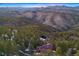 Aerial view of the house, in the middle of a valley at 29011 Upper Moss Rock Rd, Golden, CO 80401