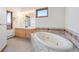 Luxurious bathroom with a soaking tub, vanity, and views, ideal for relaxation and rejuvenation at 29011 Upper Moss Rock Rd, Golden, CO 80401