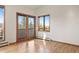 Bright bedroom featuring wood floors, large windows, and a balcony offering mountain views at 29011 Upper Moss Rock Rd, Golden, CO 80401