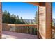 An exterior deck with a wood railing with an open view of the surrounding nature at 29011 Upper Moss Rock Rd, Golden, CO 80401