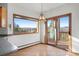 Sunny dining room with a view of the mountains and access to the deck at 29011 Upper Moss Rock Rd, Golden, CO 80401