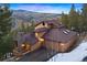 Exterior view of the house at dusk with lights on at 29011 Upper Moss Rock Rd, Golden, CO 80401