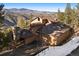 Mountain home exterior featuring a stone chimney at 29011 Upper Moss Rock Rd, Golden, CO 80401