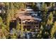 Mountain home with a spacious deck surrounded by trees at 29011 Upper Moss Rock Rd, Golden, CO 80401