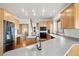 A spacious kitchen features wooden cabinets, stainless steel appliances and granite countertops at 29011 Upper Moss Rock Rd, Golden, CO 80401