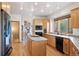 Modern kitchen with wood cabinets, stainless steel appliances, and a view into the living room at 29011 Upper Moss Rock Rd, Golden, CO 80401