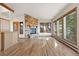 Open living room featuring a stone fireplace and wood floors at 29011 Upper Moss Rock Rd, Golden, CO 80401