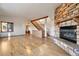 Spacious living room with stone fireplace and staircase at 29011 Upper Moss Rock Rd, Golden, CO 80401