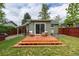 Backyard features a wooden deck with seating area and sliding glass doors to the home at 4520 S Delaware St, Englewood, CO 80110