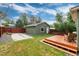Spacious backyard with wooden deck, concrete area and a shed offers ample space for recreation at 4520 S Delaware St, Englewood, CO 80110