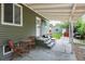 Covered back patio with seating area, perfect for relaxing and enjoying the outdoors at 4520 S Delaware St, Englewood, CO 80110