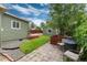 Landscaped backyard with brick patio, wooden deck and shed offers ample space for outdoor activities at 4520 S Delaware St, Englewood, CO 80110