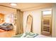 A stylish basement bedroom with a modern mirror, comfortable couch, and bright lighting at 4520 S Delaware St, Englewood, CO 80110
