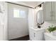 Well-lit bathroom with modern fixtures, subway tile shower and vanity with a black faucet at 4520 S Delaware St, Englewood, CO 80110