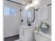 Modern bathroom with white subway tile shower and sleek black fixtures at 4520 S Delaware St, Englewood, CO 80110