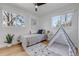 Charming bedroom with hardwood floors, a single bed, and a play tent at 4520 S Delaware St, Englewood, CO 80110