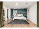 A modern bedroom featuring a stylish bed and a unique wall color at 4520 S Delaware St, Englewood, CO 80110