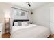 Comfortable bedroom featuring a bed with neutral linens, a ceiling fan, and lots of light at 4520 S Delaware St, Englewood, CO 80110