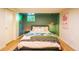 Vibrant bedroom with green walls, a comfortable bed with stylish bedding, and a window at 4520 S Delaware St, Englewood, CO 80110