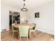 Dining room showcasing a wood table with stylish green chairs and modern decor at 4520 S Delaware St, Englewood, CO 80110