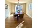 Sunlit dining room with wood floors and a round wooden table at 4520 S Delaware St, Englewood, CO 80110