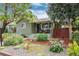 Charming home with well-maintained landscaping, a covered porch and mature trees at 4520 S Delaware St, Englewood, CO 80110